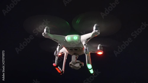 Drone hovering at night with strobes and glow sticks photo