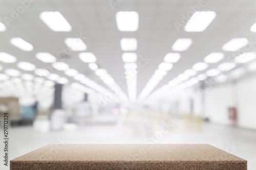 Wood table in factory building blurred background