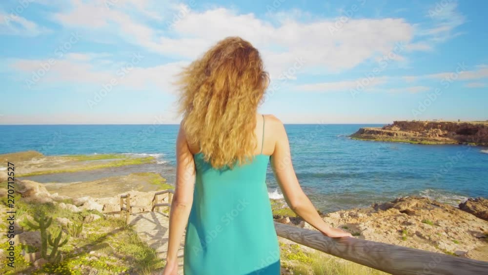 Girl is walking down a wooden staircase to the tropical coast. Recreation. Summer. Girl is walking down a wooden staircase to the tropical coast. Recreation. Summer.