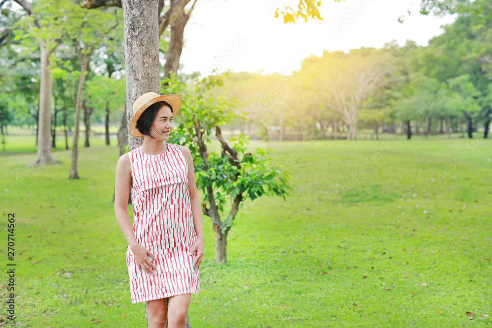 Beautiful young asian woman poses in the nature park. Beautiful young asian woman poses in the nature park.