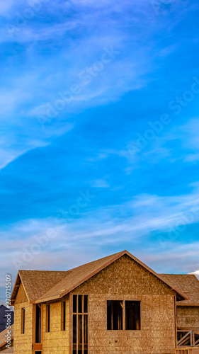 Wallpaper Mural Vertical frame Exterior of a house under construction against vivid blue sky with clouds Torontodigital.ca