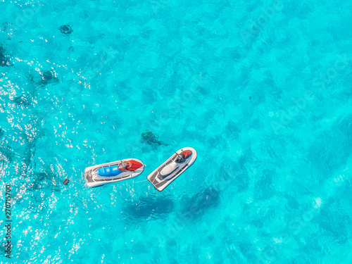 Jet skis for rent are parked in blue lagoon tropical sapphire, top view