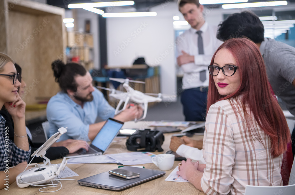 redhead business woman learning about drone technology redhead business woman learning about drone technology