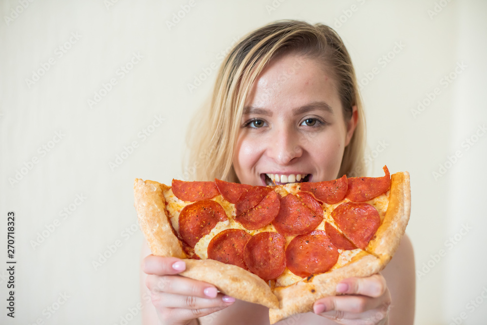 European girl with short hair posing with pieces of delicious pizza. European girl with short hair posing with pieces of delicious pizza.