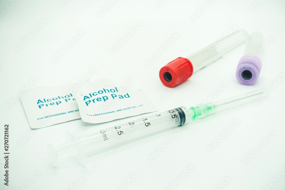 Blood taking kit, Empty syringe with needles, blood container tube and alcohol swab against isolated white background, medical concept Blood taking kit, Empty syringe with needles, blood container tube and alcohol swab against isolated white background, medical concept