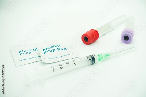 Blood taking kit, Empty syringe with needles, blood container tube and alcohol swab against isolated white background, medical concept