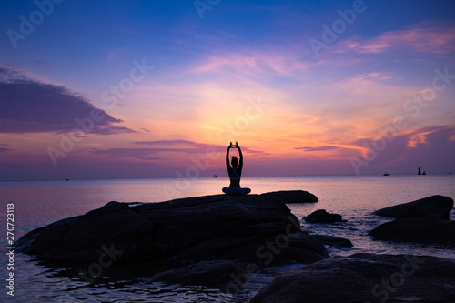 Asian girl practice Yoga on the beach Sunrise morning day