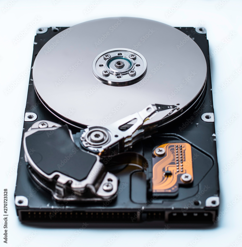 Close up of a Disassembled computer hard drive on white isolated background with reflection Close up of a Disassembled computer hard drive on white isolated background with reflection