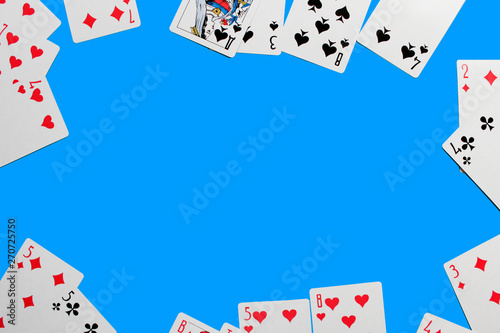 Playing card. Hand with card playing poker .close up of male hand with playing cards and chips at home. Pocker game. Casino cards as background. Concept for games, gambling in casino and sports poker.