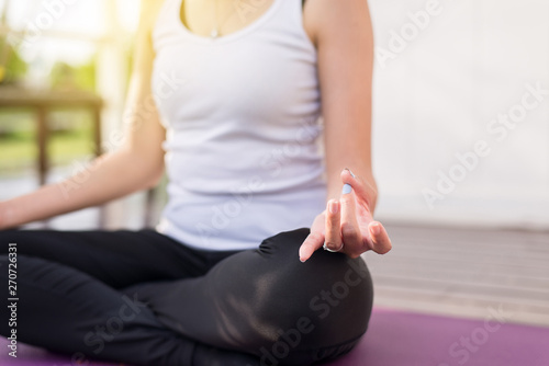 Woman practices yoga and meditation on the lotus posture