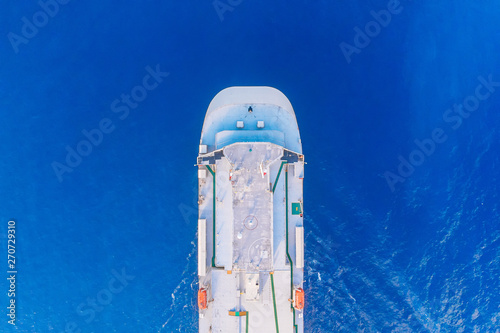 Car carrier shipping out trade port blue sea. Aerial top view © Parilov