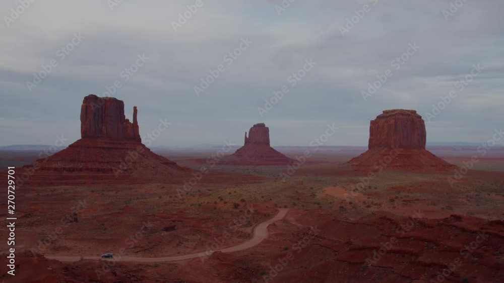 FIXED Cars passing by red rock formations in Monument Valley, Arizona, USA. 4K UHD 60 FPS SLOW MOTION FIXED Cars passing by red rock formations in Monument Valley, Arizona, USA. 4K UHD 60 FPS SLOW MOTION