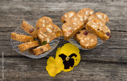 Slices of baked sweets from shortbread dough with caramel and nuts homemade