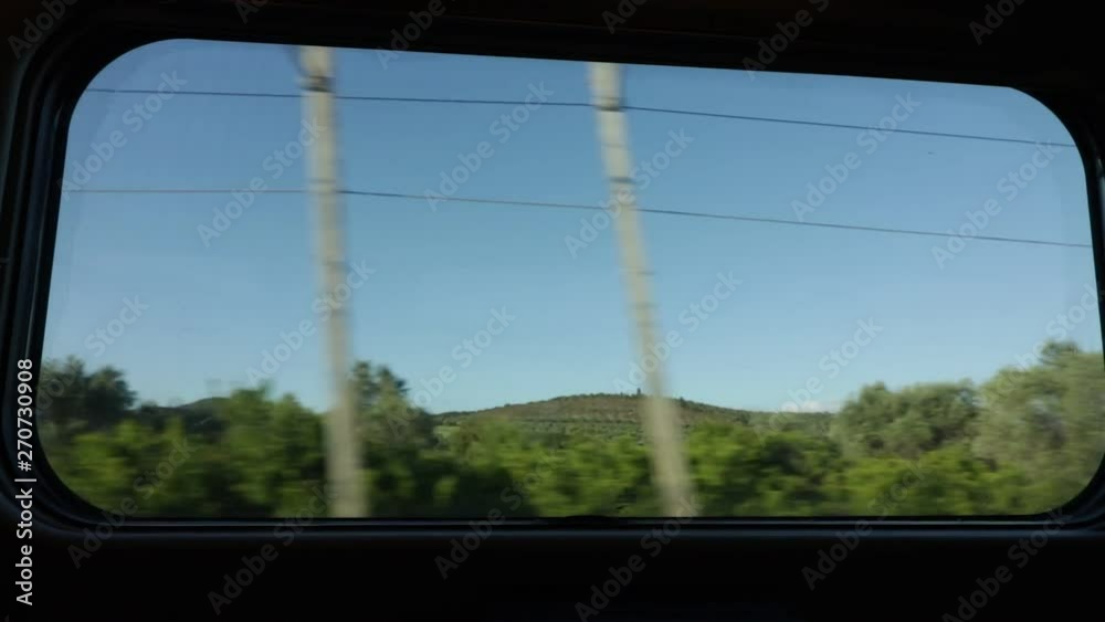 Tuscan countryside seen from the train window. Green landscape of the Tuscan Maremma with the speed of the train. Tuscan countryside seen from the train window. Green landscape of the Tuscan Maremma with the speed of the train.