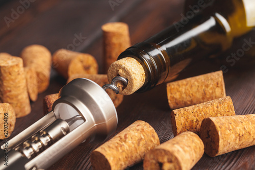 Opening wine bottle with a corkscrew close up