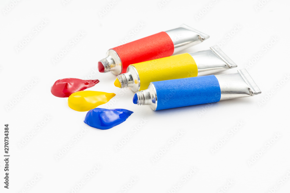 Three of the primary colour flow out of the tube on rough white paper Three of the primary colour flow out of the tube on rough white paper