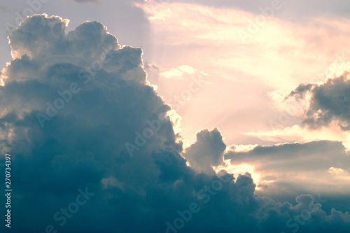 Fototapeta Naklejka Na Ścianę i Meble -  Sun rays breaking through dark clouds at sunset.