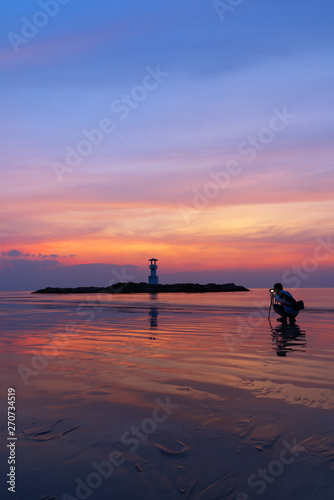 Silhouettes photographer and tourists in the evening sunset viewpoint,Lighthouse. Khao Lak, Phang Nga, Thailand.