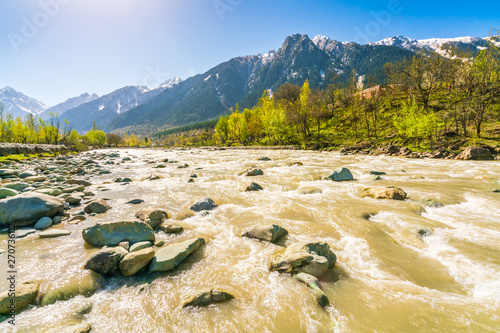 Beautiful River and snow covered mountains landscape Kashmir state, India .