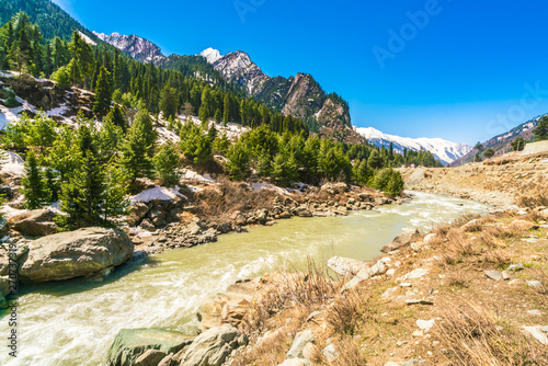 Beautiful River and snow covered mountains landscape Kashmir state, India .