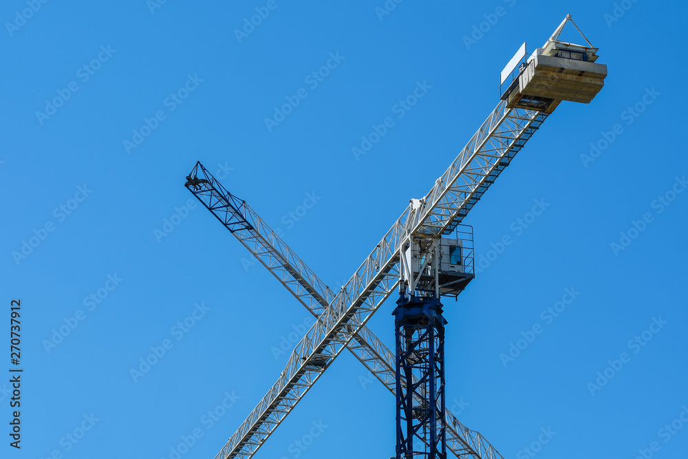 image of a tower crane at the construction site of a residential house image of a tower crane at the construction site of a residential house