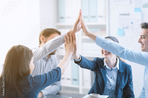 Successful young business team giving high five