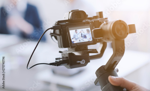 Professional videomaker shooting a video photo