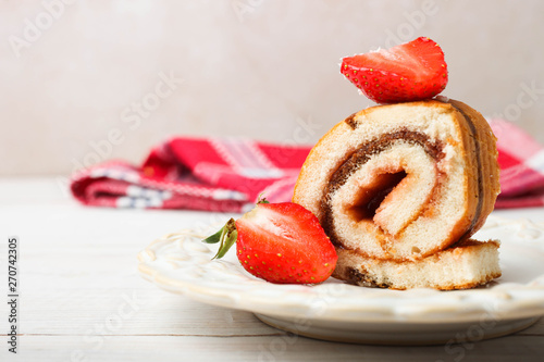 Slice of sweet roll with jam and strawberries