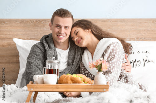 Cute young couple having br...