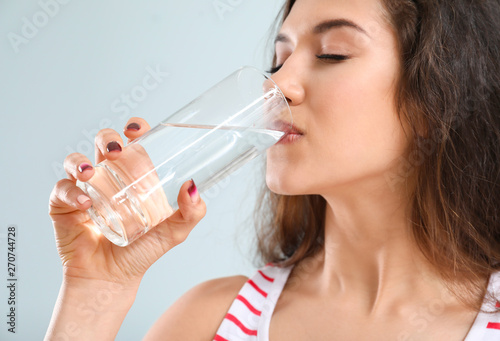 Beautiful young woman drink...