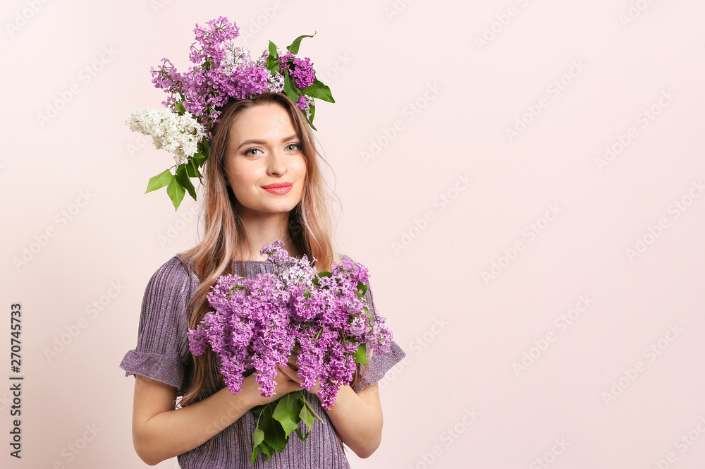 Beautiful young woman with lilac flowers on light background Beautiful young woman with lilac flowers on light background