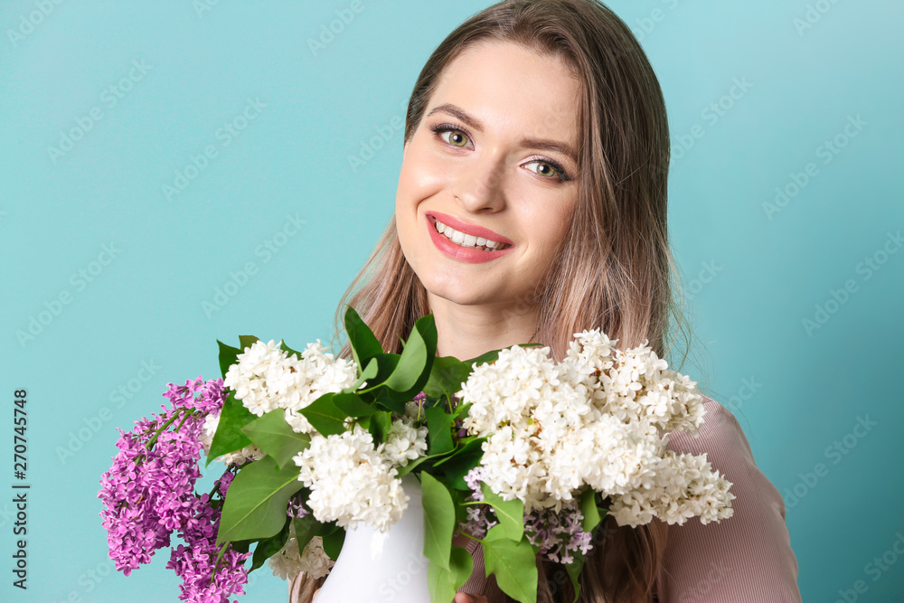 Beautiful young woman with bouquet of lilac flowers on color background Beautiful young woman with bouquet of lilac flowers on color background