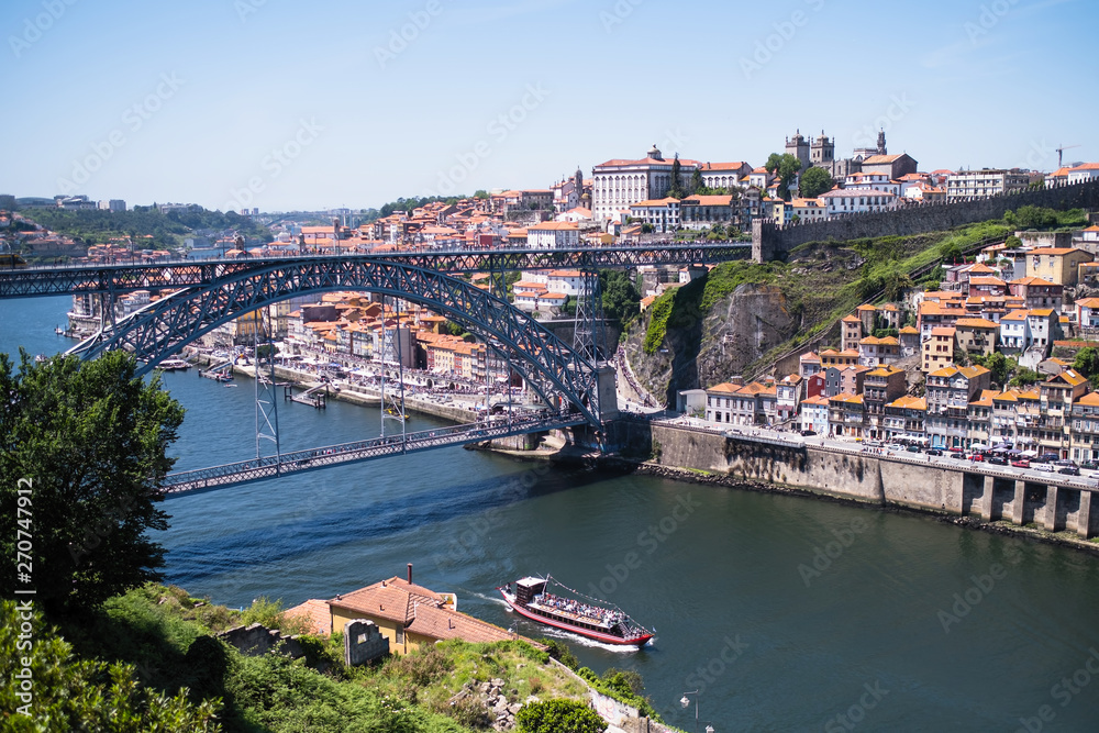 View of the Douro river and Dom Luis I Bridge in Porto, Portugal.