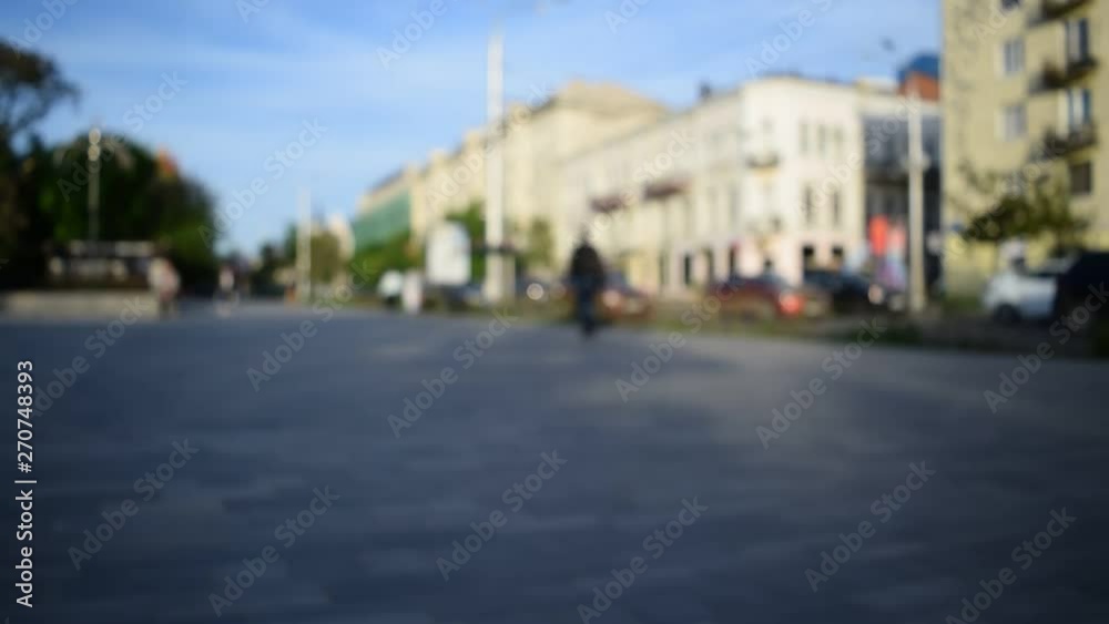 People on a blurred background on a sunny day go through the city, they drive cars People on a blurred background on a sunny day go through the city, they drive cars