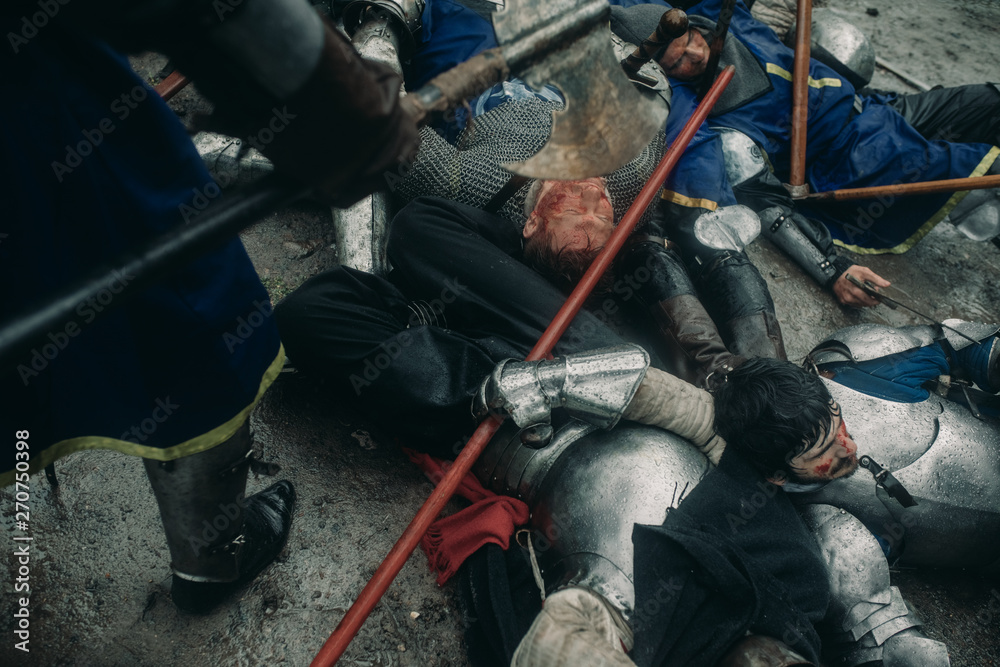 The murdered medieval knights crusaders lie on the battlefield. The murdered medieval knights crusaders lie on the battlefield.