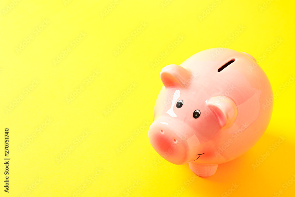 Happy piggy bank on yellow background, space for text. Finance, saving money Happy piggy bank on yellow background, space for text. Finance, saving money