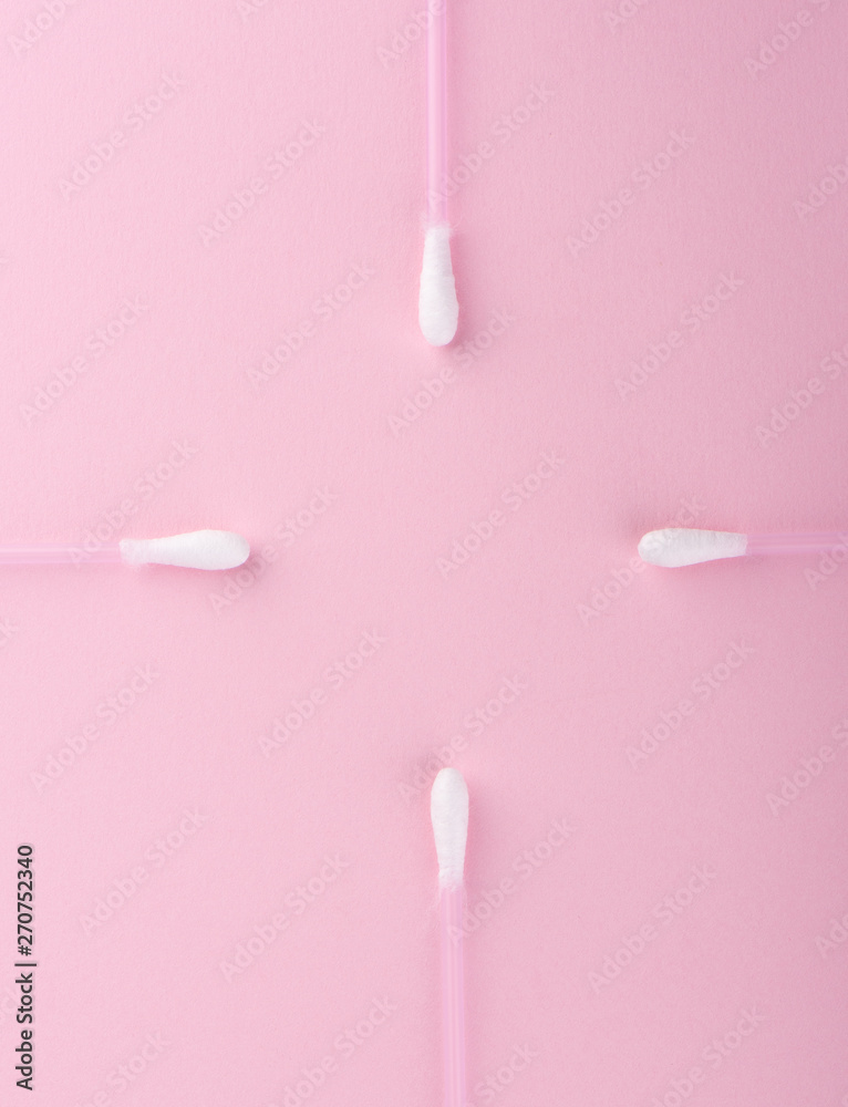Cotton buds over a pink background. Hygienic supplies.