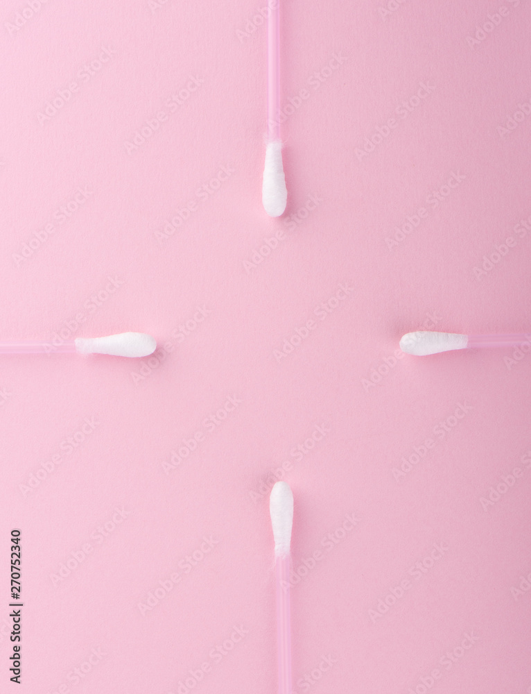 Cotton buds over a pink background. Hygienic supplies. Cotton buds over a pink background. Hygienic supplies.
