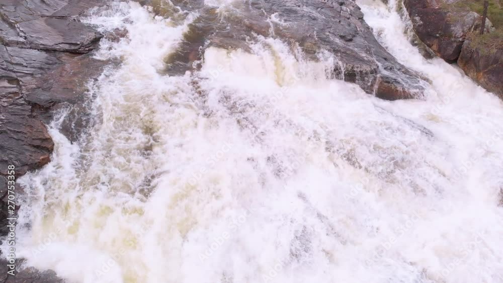 White water rapids river with rocks on either side. Trees on the side of the river. White water rapids river with rocks on either side. Trees on the side of the river.