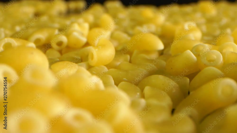 Dolly Shot Of coquillettes or cornettes Pasta on black table Dolly Shot Of coquillettes or cornettes Pasta on black table