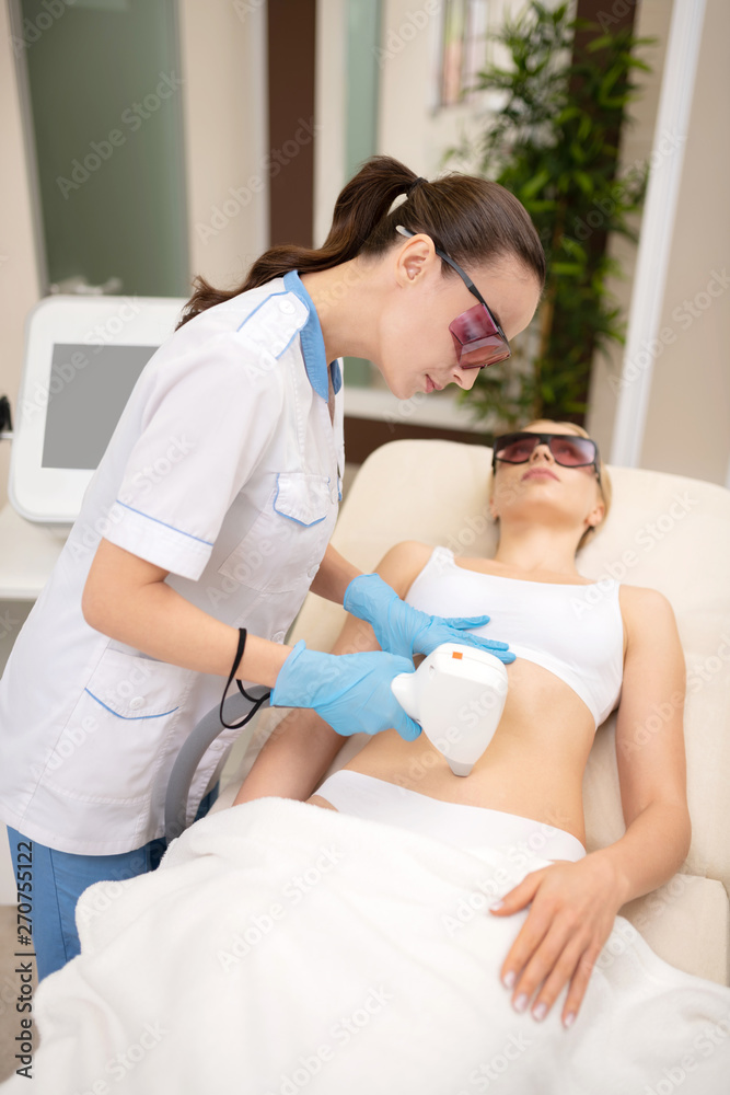 Obraz premium Client wearing underwear having laser depilation near navel