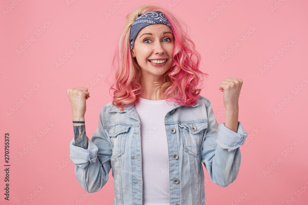 Happy smiling nice lady with pink hair and tattooed hands, standing ...