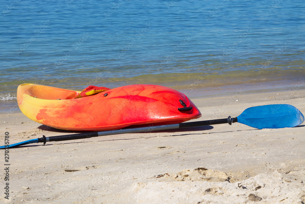 colorful kayak with paddle on a tropical beach in sunny summer colorful kayak with paddle on a tropical beach in sunny summer