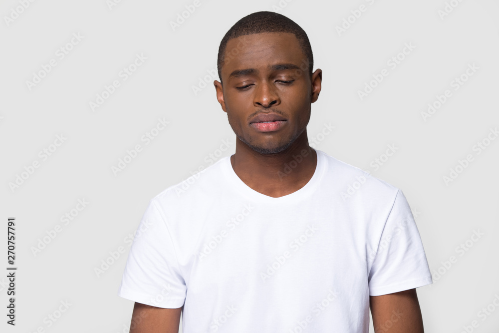 Head shot sad african male studio portrait on grey background Head shot sad african male studio portrait on grey background