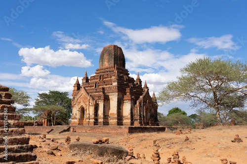 Old Bagan Pagodas in Myanmar with clouds and light blue sky.