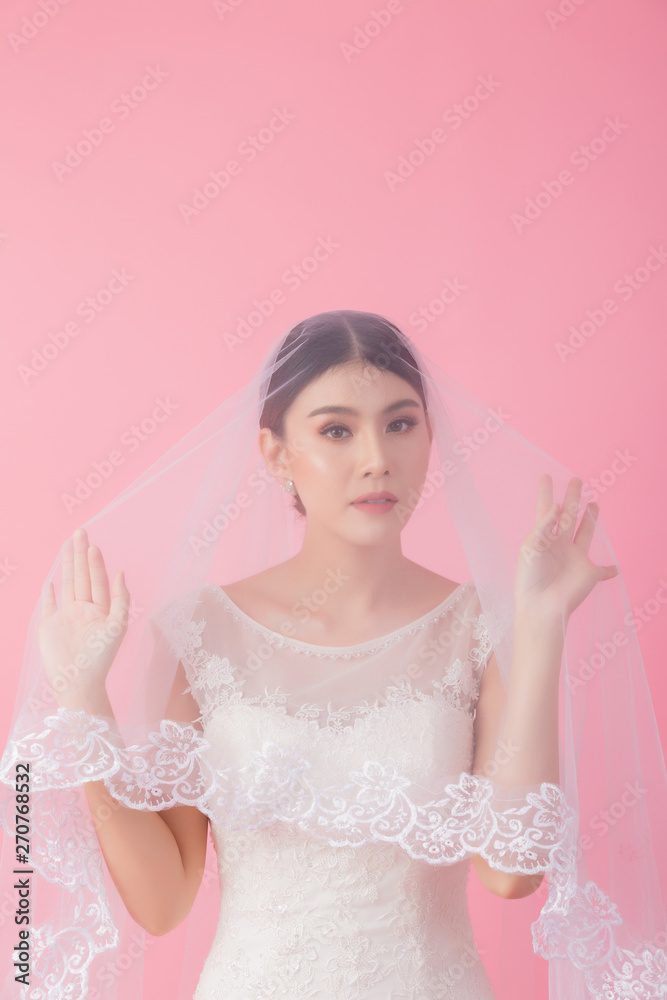 Beautiful asian bride portrait in pink studio