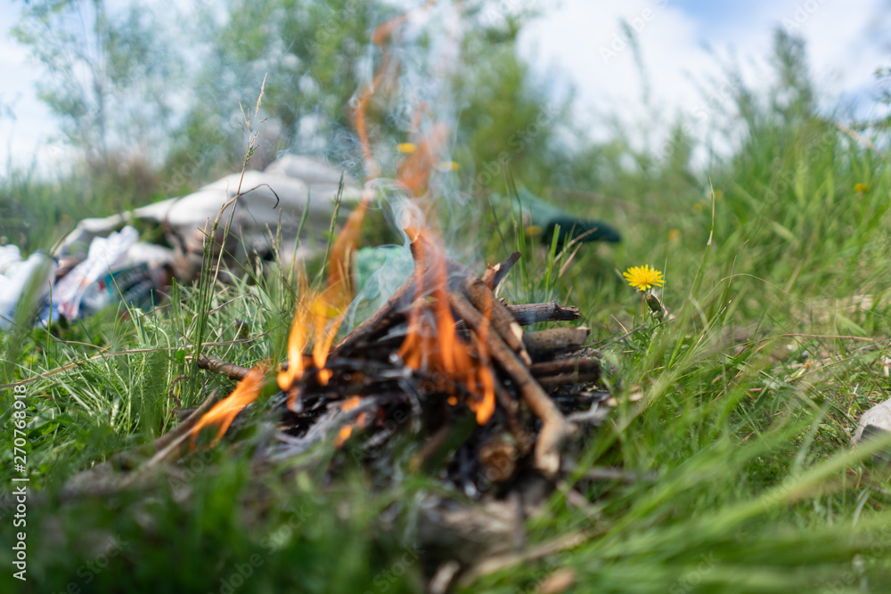 small bonfire on the stone, in nature. from small twigs small bonfire on the stone, in nature. from small twigs
