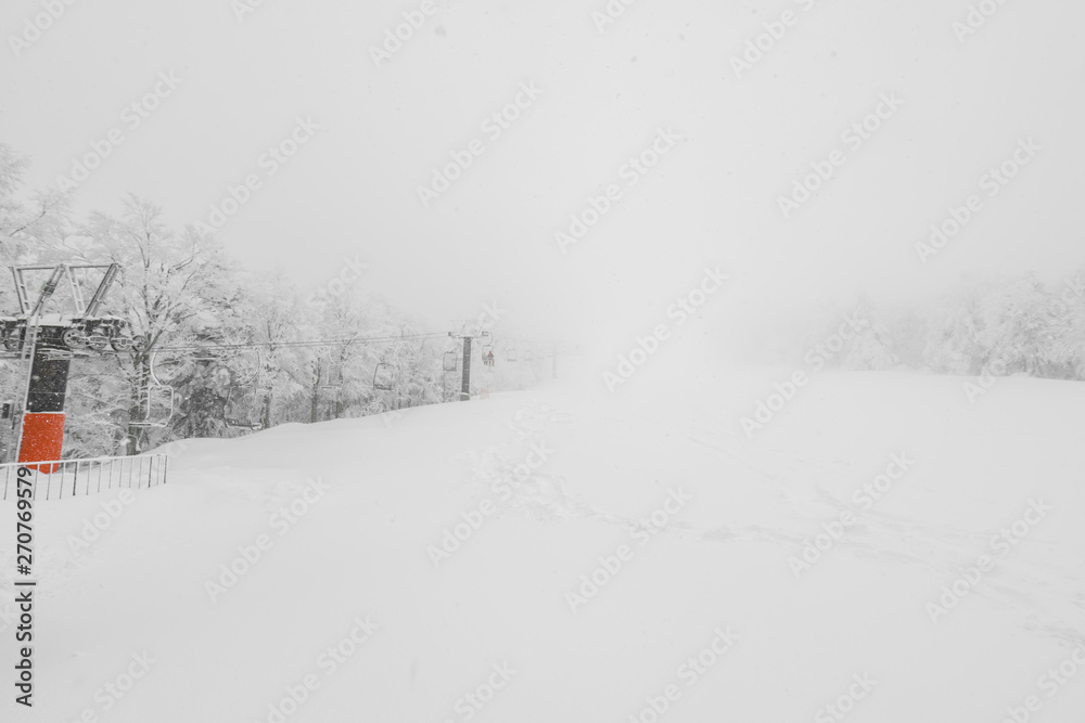 Fototapeta premium Ski lift over snow mountain in ski resort .