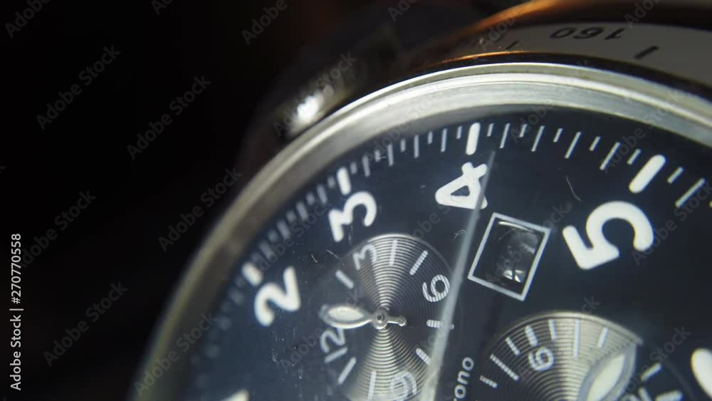 Close up shot of a wrist watch with white clock hands moving. Close up shot of a wrist watch with white clock hands moving.