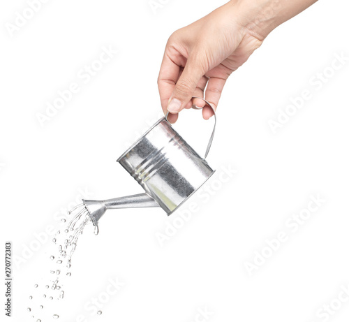 Foto hand holding a small metal watering can with spout isolated on white background